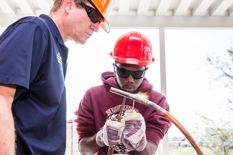 Students learning HVAC skills